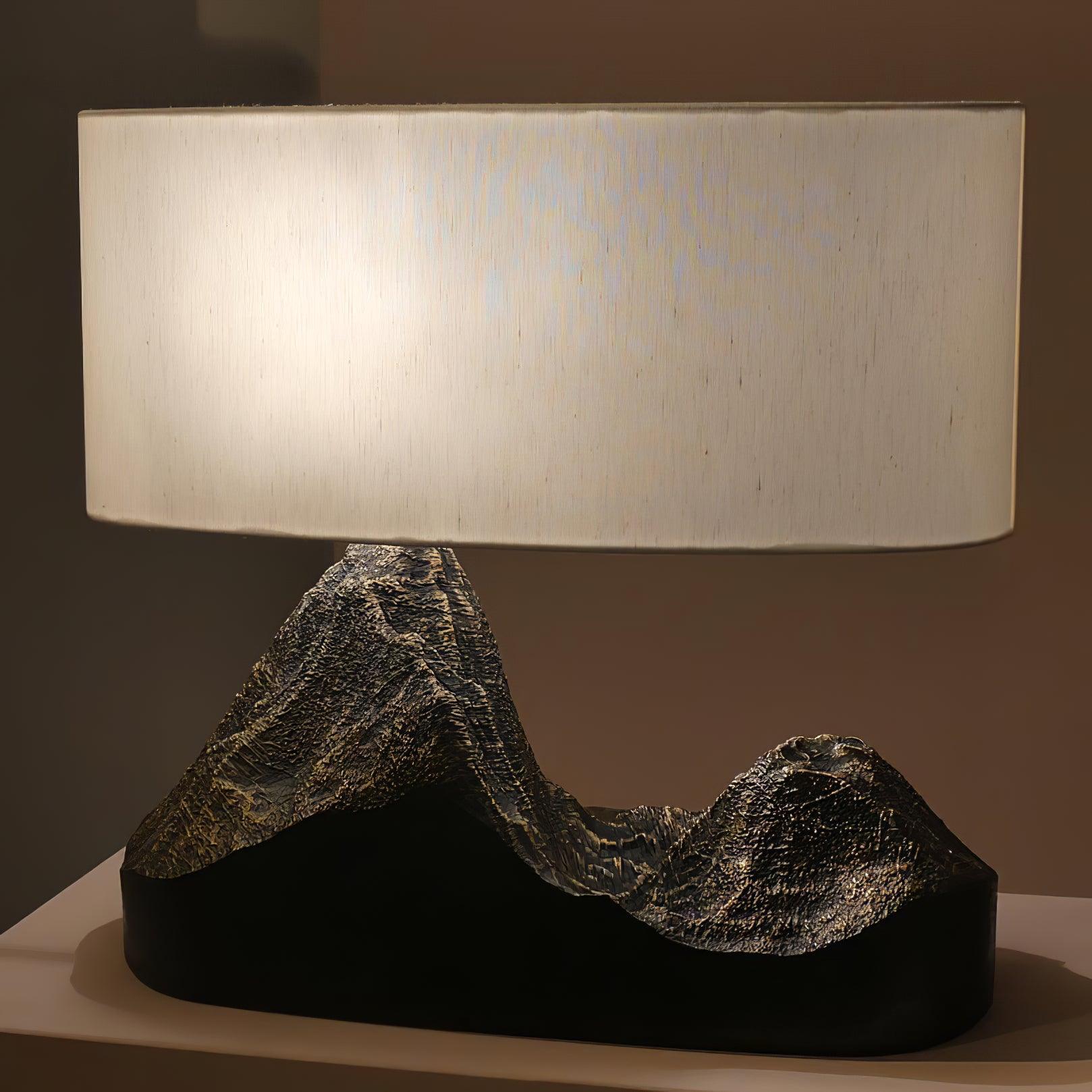 Table lamp with a textured base and beige shade on a neutral background