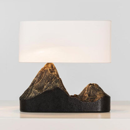 Table lamp with mountain-shaped base on a light background