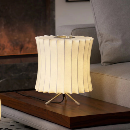 Table lamp with ribbed design on a wooden surface in a living room setting